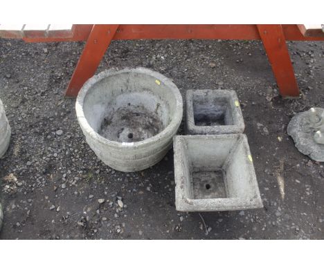A concrete circular garden planter and two square garden planters 
