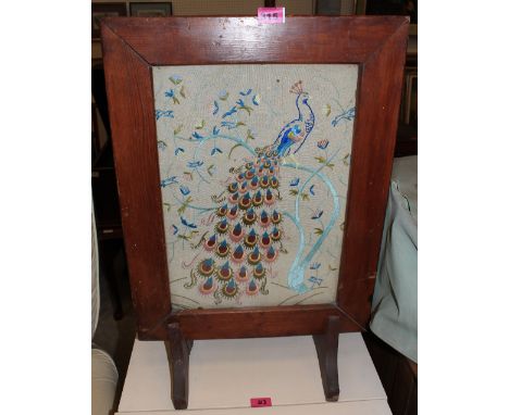 	A firescreen with embroidered panel of a peafowl