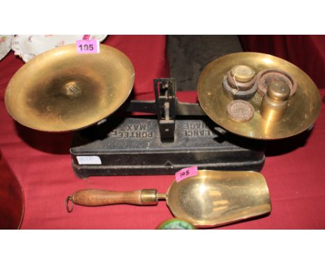 	French cast iron weighing scales with brass pans together with a brass scoop