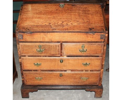 An 18th Century oak bureau, the sloping fall over two short and two long drawers, on bracket feet. 36" wide