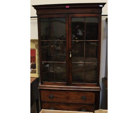 A 19th Century mahogany bookcase enclosed by a pair of glazed doors (2 panes cracked) over base with three long drawers, on b