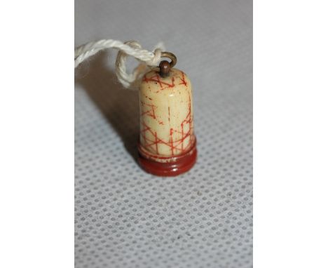 	A tiny carved bone thimble form case containing 5 playing dice