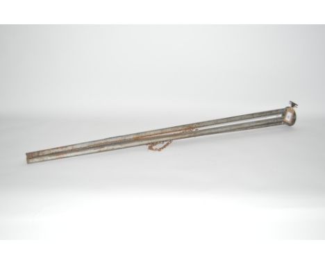 A metal World War II search light tripod, fully marked