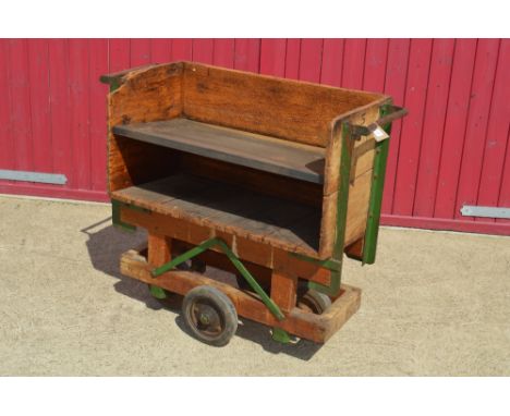 A Vintage wooden trolley cart with metal shelf