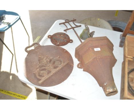 A cast iron rain hopper; a circular heavy griddle; a wall applique; a sign dated 1948, GWR; a bell on bracket and a iron mark