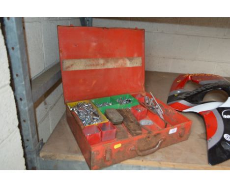 A Vintage red metal toolbox and various contents therein