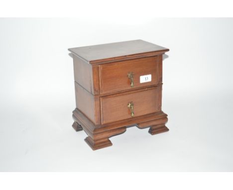 A mahogany two drawer trinket chest, 10ins wide x 10.5ins high approx.