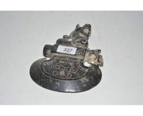 An ornate hardstone axe head