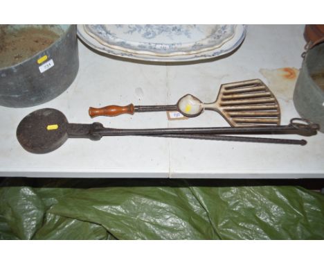 An unusual iron and enamel decorated griddle and an iron waffle press