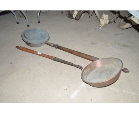 An Antique copper warming pan with turned wooden handle and a large copper long handled pan or ladle