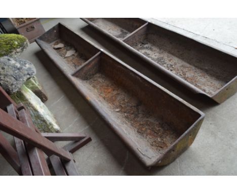 A heavy 8ft cast iron two section feed trough