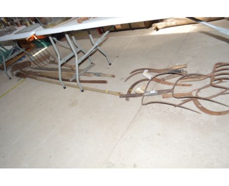 A collection of various Bygone agricultural tools to include pitch fork ends, slashers, beet fork, long handled scoops etc.