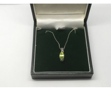 A 9ct white gold chain with a marquis shaped peridot pendant, approx 2g.