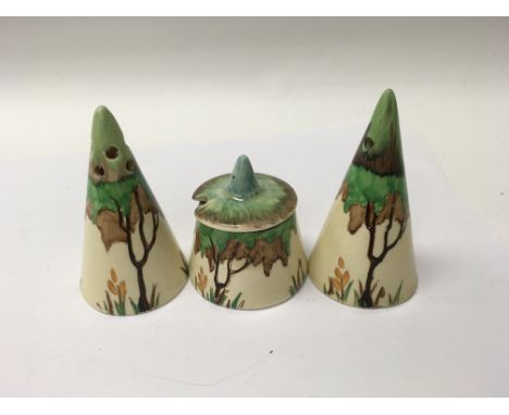 A Clarice Cliff three piece cruet set decorated with trees flowers and foliage