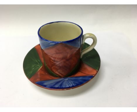 A Clarice Cliff coffee can and saucer decorated in a geometric pattern
