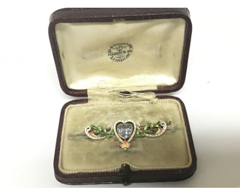 A Quality Antique gold and enamel brooch set with an aquamarine coloured stone in a fitted box.