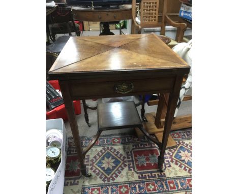 An inlaid Edwardian envelope card table, the tapering legs united by an undertier shelf below, approx 56cm x 56cm x 75cm.