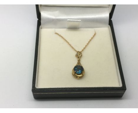 A 9ct gold, diamond and peacock kianite pendant on a 9ct gold chain, approx 2.5g.