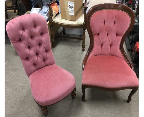 Two, low button back chairs with pink upholstery