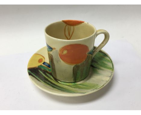 A Clarice Cliff coffee can and saucer decorated in orange and lemons