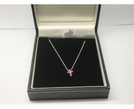 An 18ct white gold chain with a small crucifix set with pink sapphires, approx 1.9g.