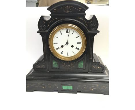 A Victorian black slate and green malachite mantel clock with a white enamel dial and French movement striking on a bell. wit