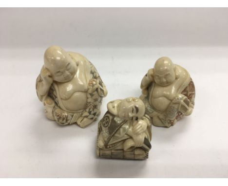 Three ivory buddhas including one netsuke.