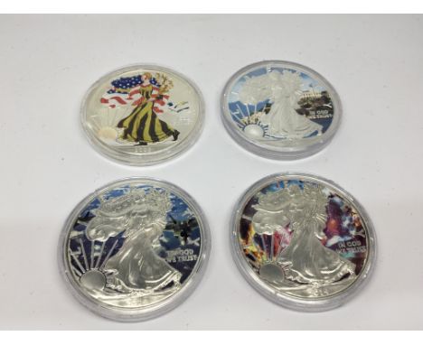 A Collection of Four American Silver Dollars enamel decorated.uncirculated US mint coins. Each One once of fine silver (9.99%