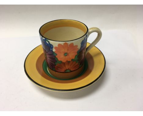A Clarice Cliff coffee can and saucer in the gay day pattern .
