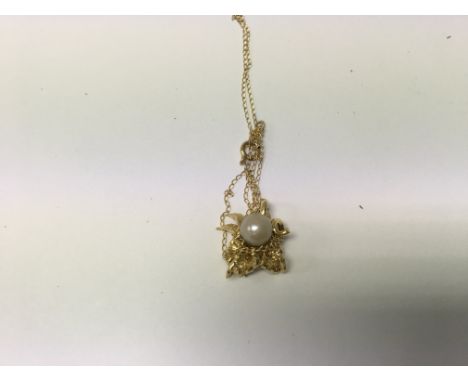 A 9 ct gold chain with attached pearl  pendant