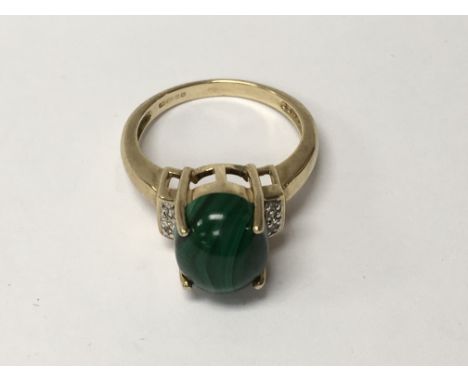 A 9 k gold ring inset with malachite and white Topaz size N