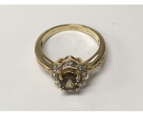 A 9 k gold ring inset with change garnet and diamonds size O