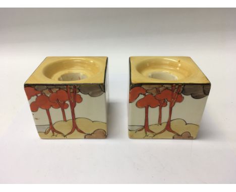 A pair of Clarice Cliff coral firs cube candle sticks shape 658, 6 cm