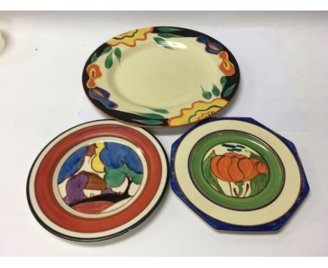 A Clarice Cliff side plate decorated in the autumn pattern and two other Clarice Cliff plates