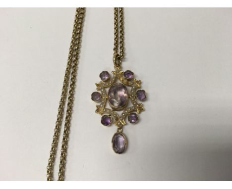 A Edwardian 15 ct gold pendant inset with amethyst stones and seed pearl on attached 9 ct gold chain 8 grams