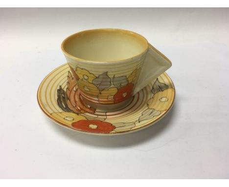 A Clarice Cliff cup saucer decorated in the coral firs pattern