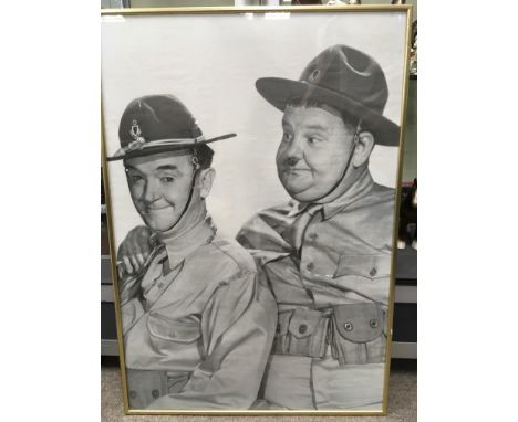 A framed Laurel &amp; Hardy poster, DVDs, book etc.