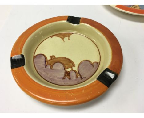A Clarice Cliff ash tray decorated with roof top and clouds