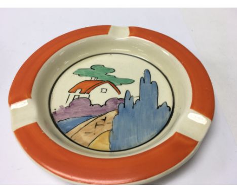 A Clarice Cliff ash tray decorated with house and trees