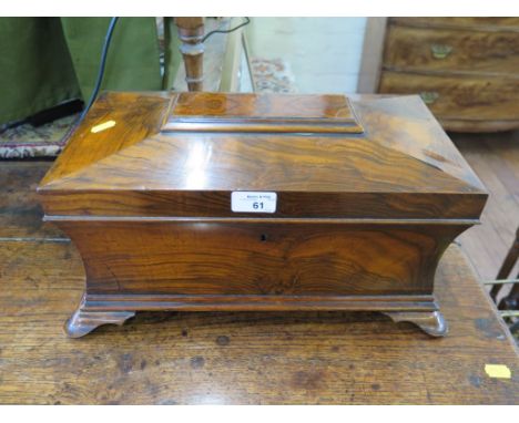 An early 19th century rosewood tea caddy of waisted sarcophagus form with ring handles and ogee bracket feet, enclosing two c
