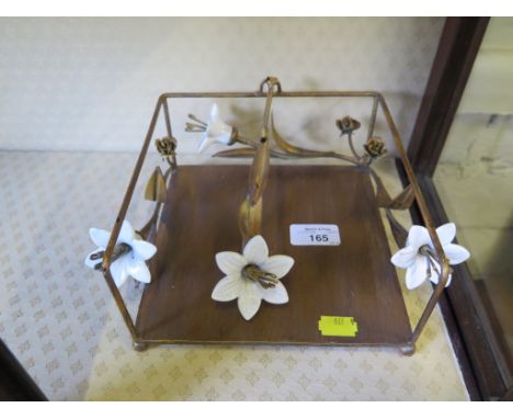 An Art Nouveau table napkin holder, with ceramic flower head design