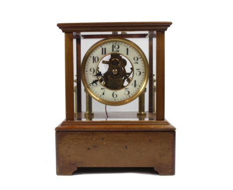 A Eureka mahogany cased electric mantel clock with electromagnetic balance wheel in a bevelled glass case, stamped Eureka Clo