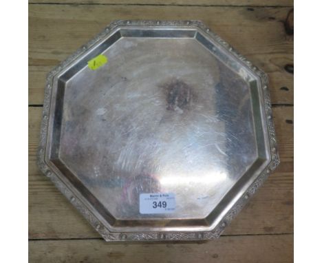 An octagonal silver salver on four bun feet having Celtic decoration to edge, Birmingham 1913