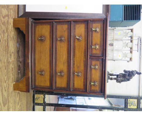 A George II style elm and mahogany crossbanded chest of drawers, with two short and three long graduated drawers on bracket f