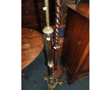 A gilt brass standard lamp on tripod base and a barley twist oak standard lamp
