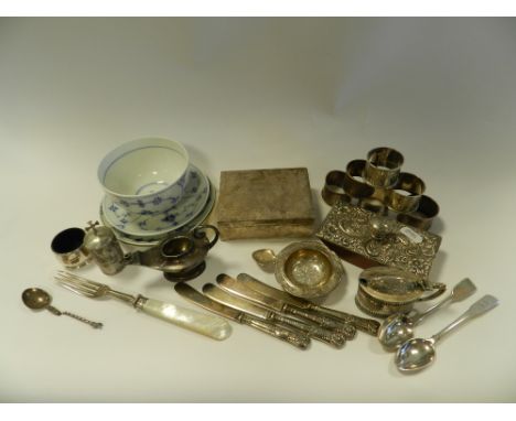 A collection of silver napkin rings together with a silver miniature Aladdin's lamp burner, a silver mounted blotter, a silve