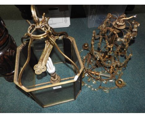 A wrought iron mirror and attached lights with shades and support bracket and also a hall lantern and chandelier