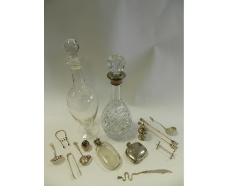 A silver mounted cut glass decanter together with a further glass decanter, a silver sugar sifter spoon, a white metal topped