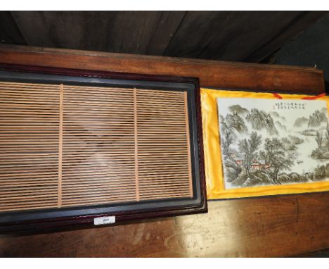 A cased Chinese porcelain landscape plaque with a Grisaille landscape and iron red enamel detailing and calligraphic inscript