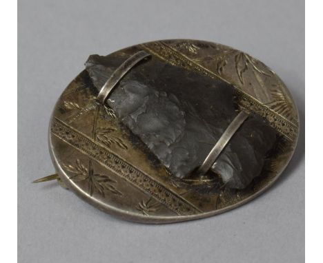 A Neolithic Arrow Head Mounted on a Silver Brooch, 4.25cms Long 